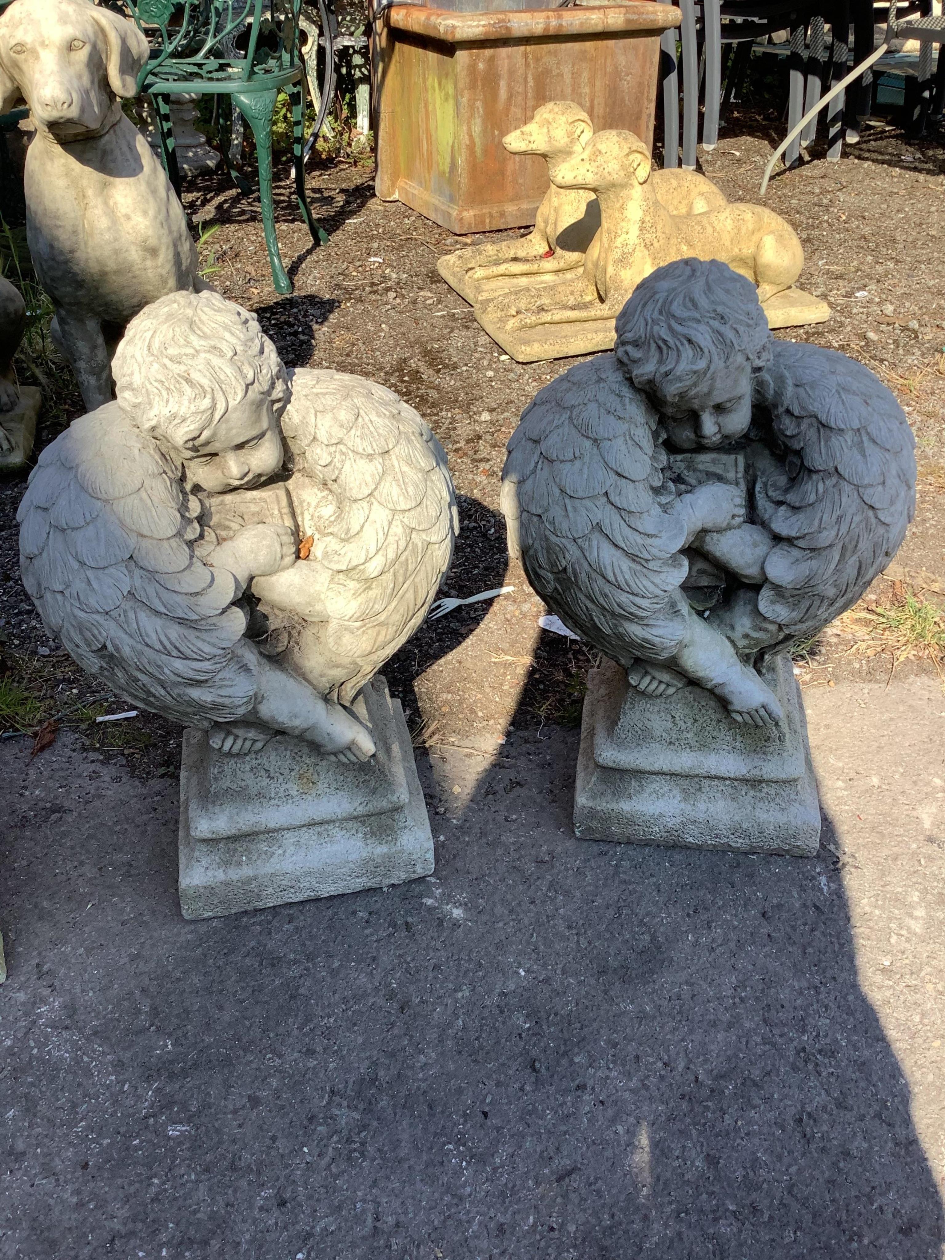 A pair of reconstituted stone angel garden ornaments, height 55cm. Condition - good